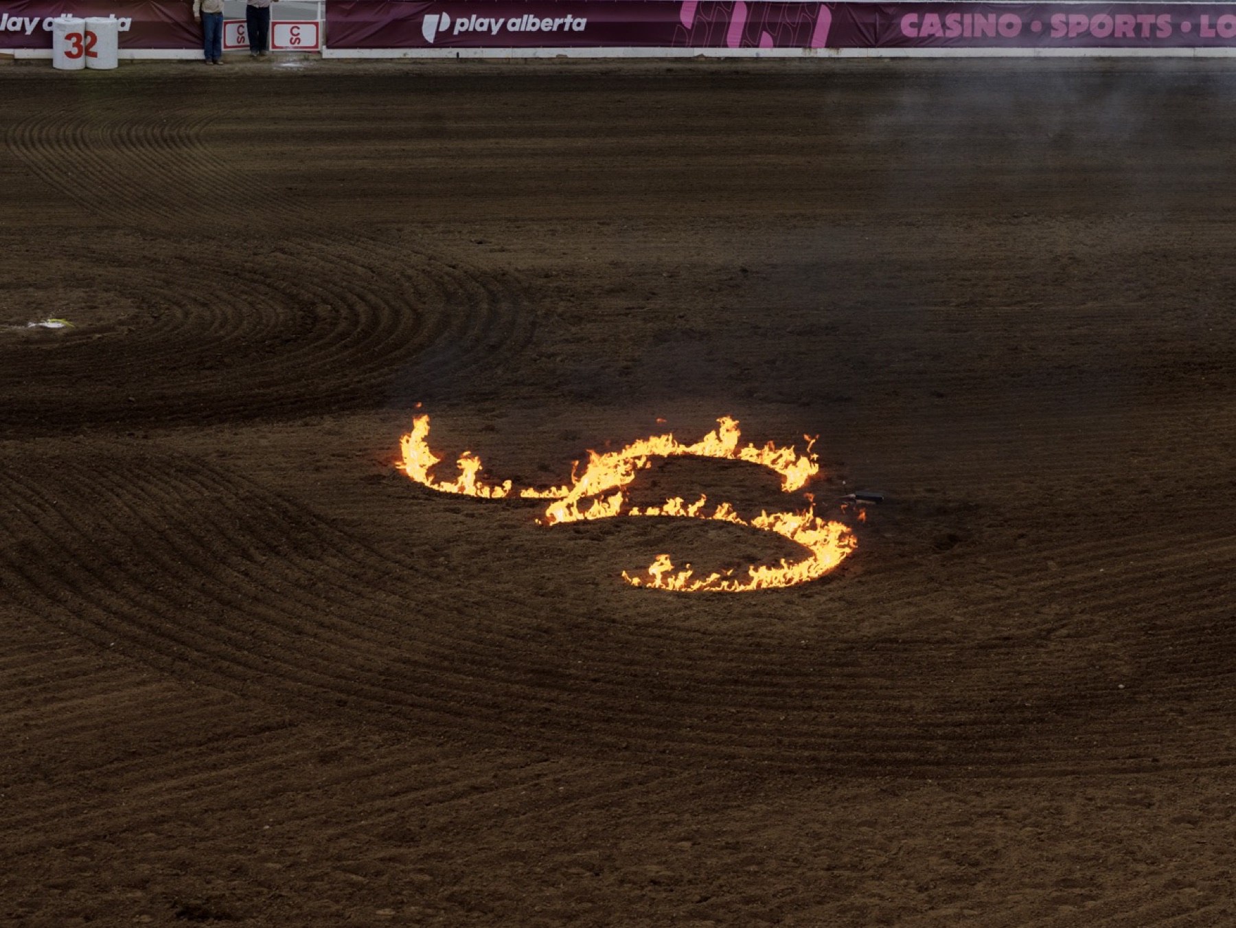 A burning mark in a dark arena floor.